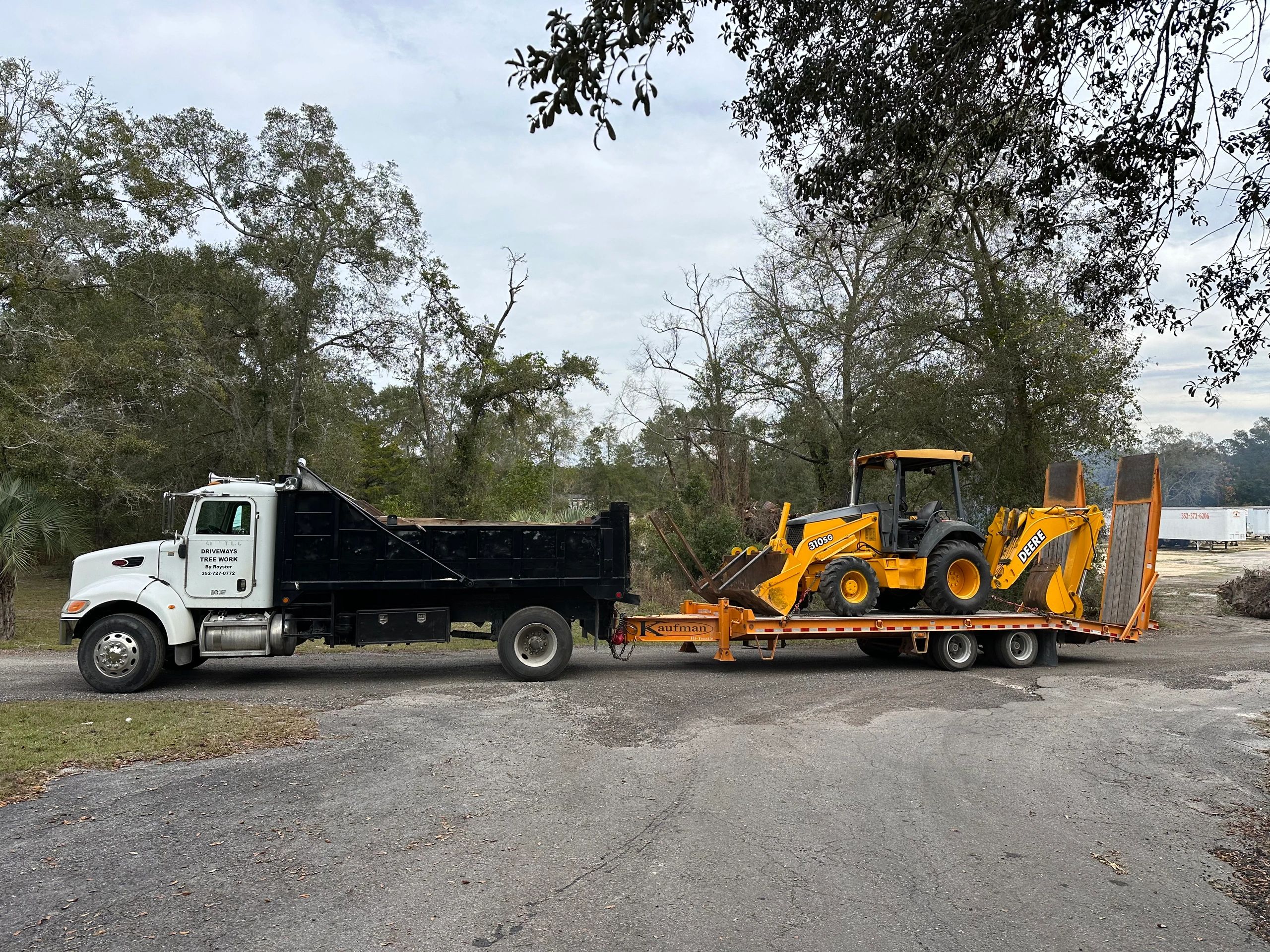 Dump truck and backhoe rolling to the next job
