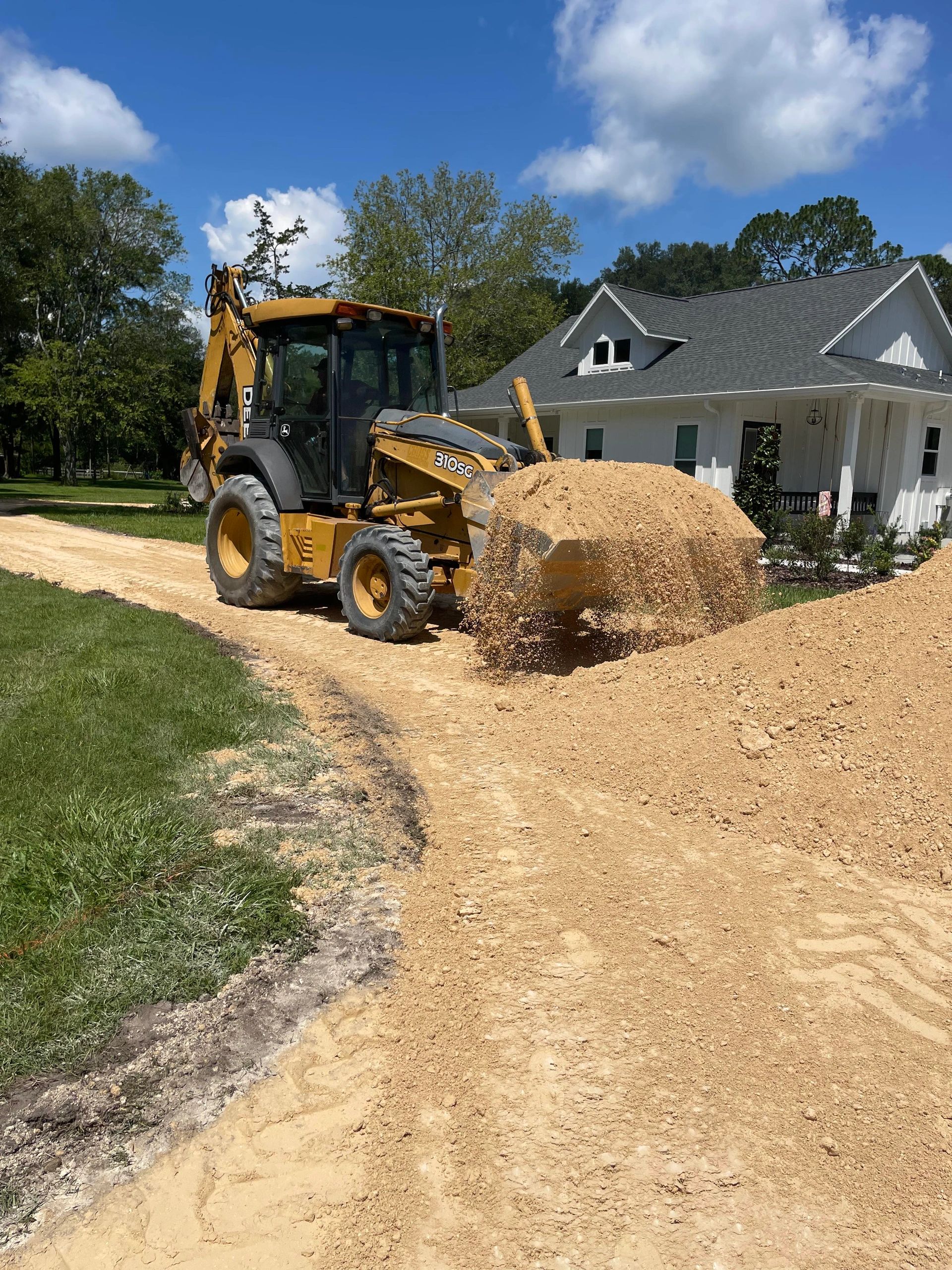 Spreading fill for a farmhouse driveway
