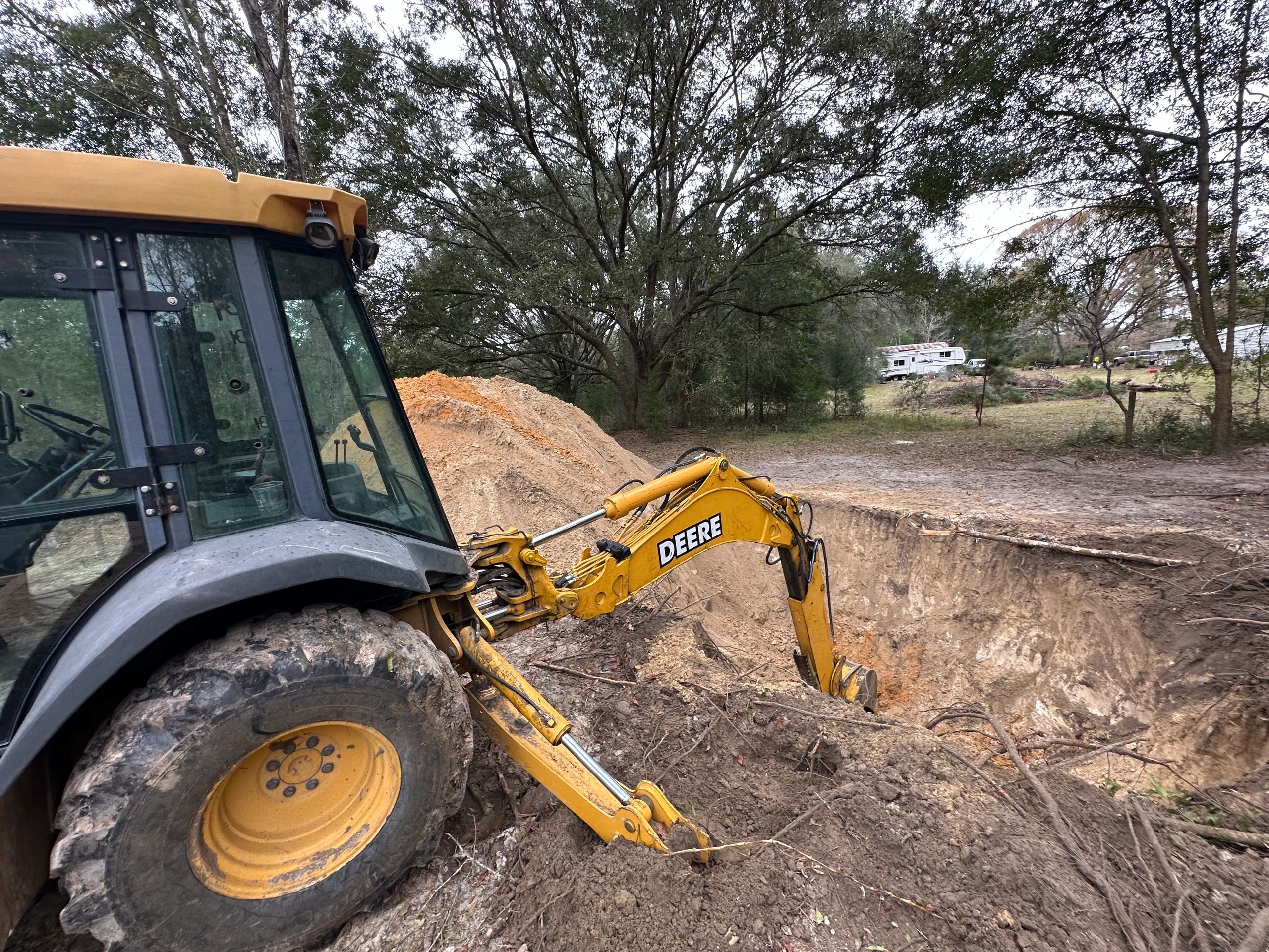 Backhoe digging out for a build site