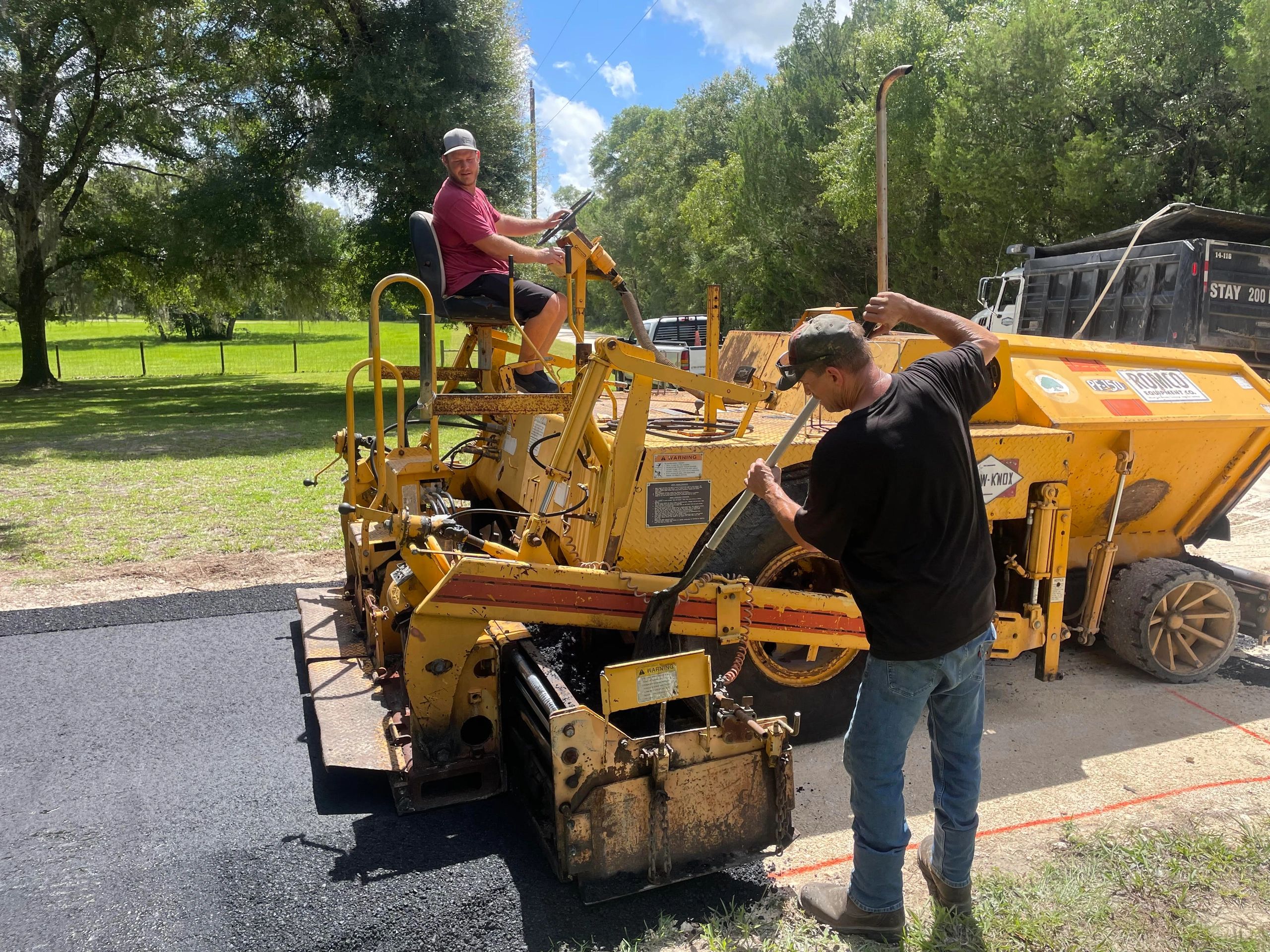 Our crew laying hot asphalt with the paver